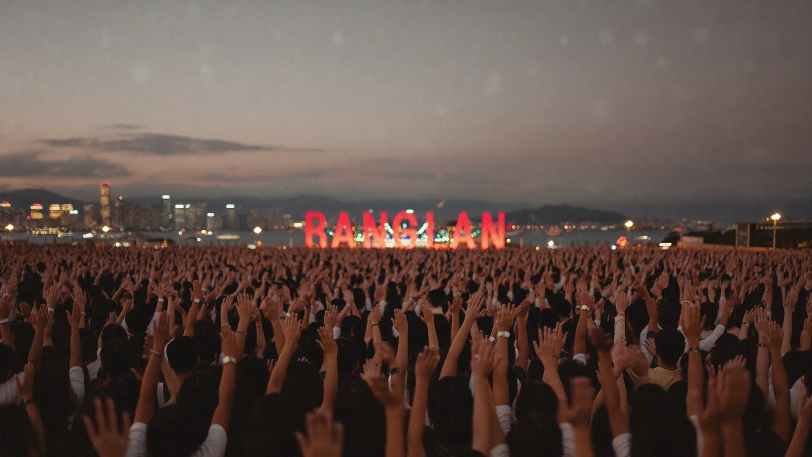 Illustrative image of an outdoor harbourfront music festival stage at dusk