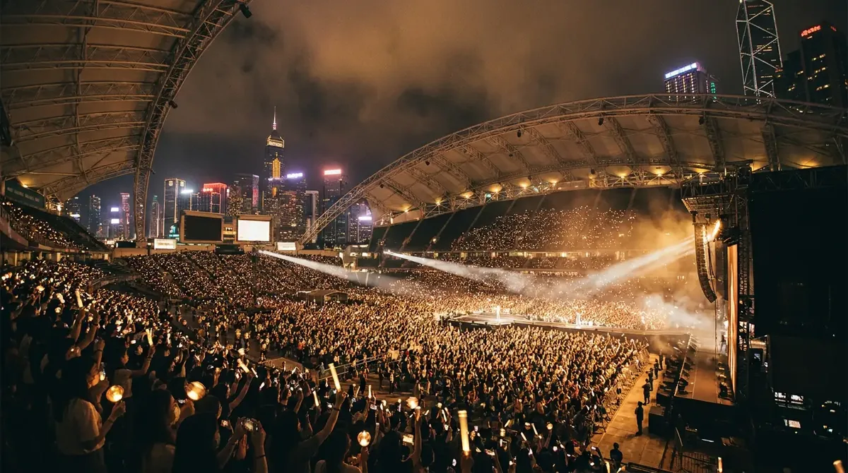 Kai Tak Stadium packed and lit up at night with the Hong Kong skyline behind, illustrating the Hong Kong Football Festival