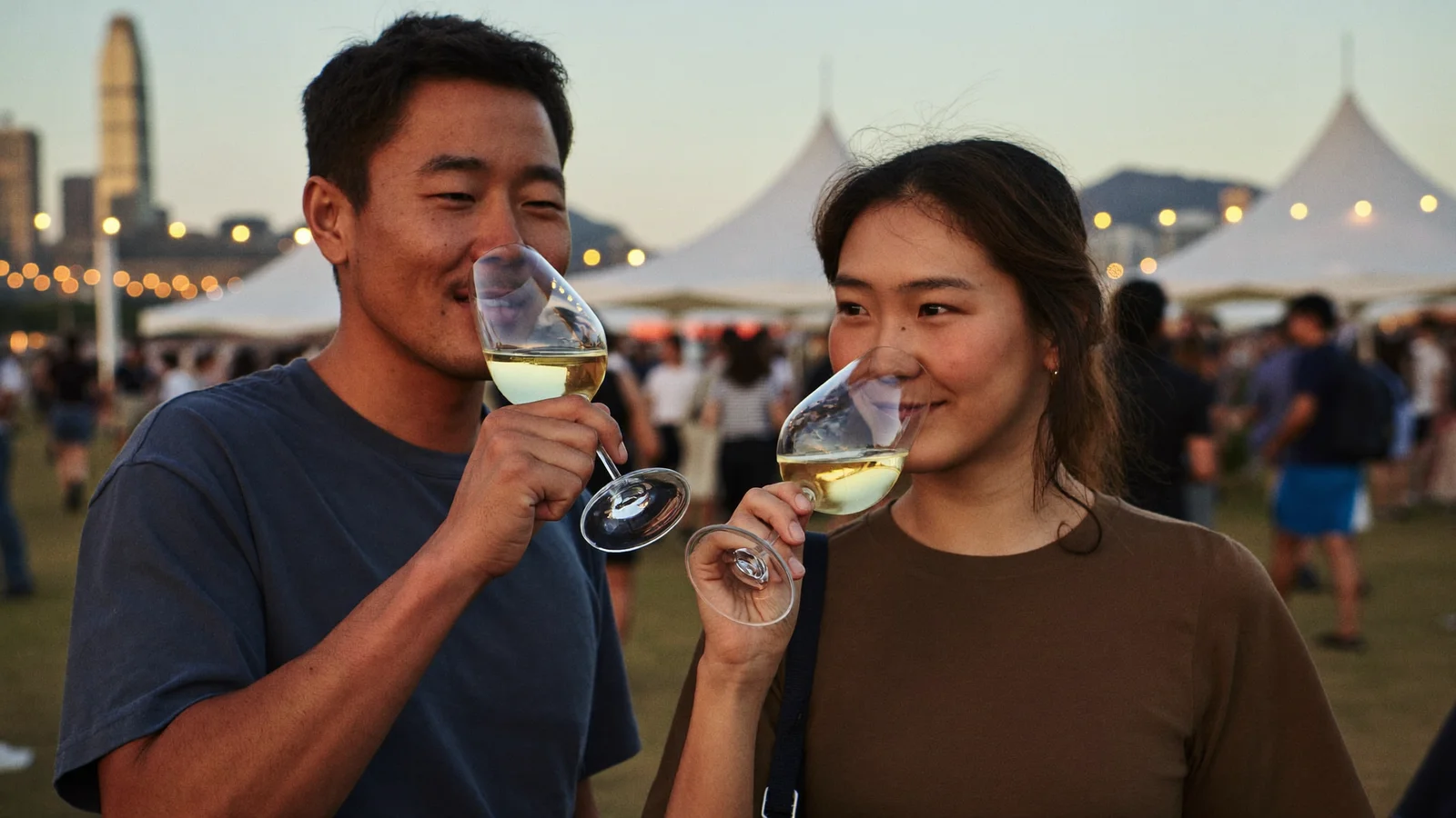 Illustrative image of people tasting wine under festival tents on a harbourfront at sunset