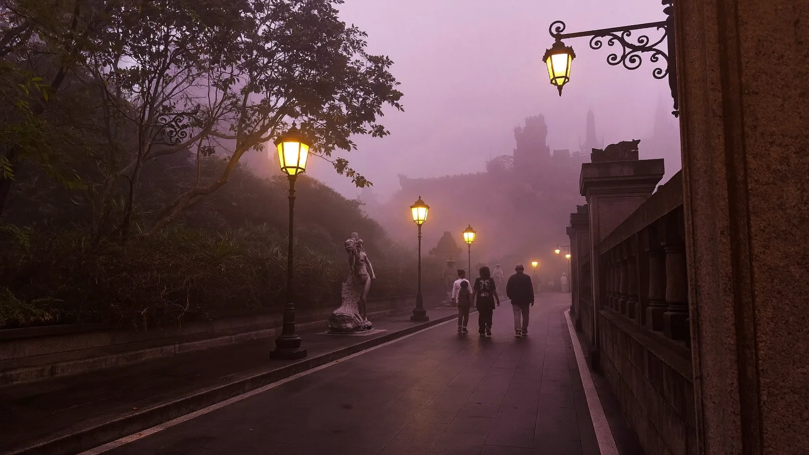Illustrative image of a misty castle-style promenade lit by old lamps at dusk