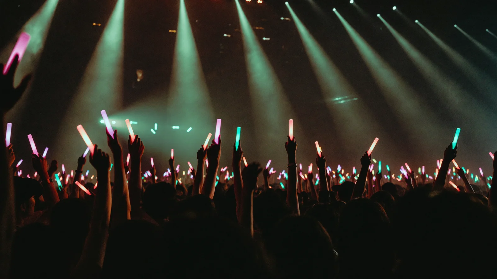 Illustrative image of a packed arena floor facing a brightly lit concert stage