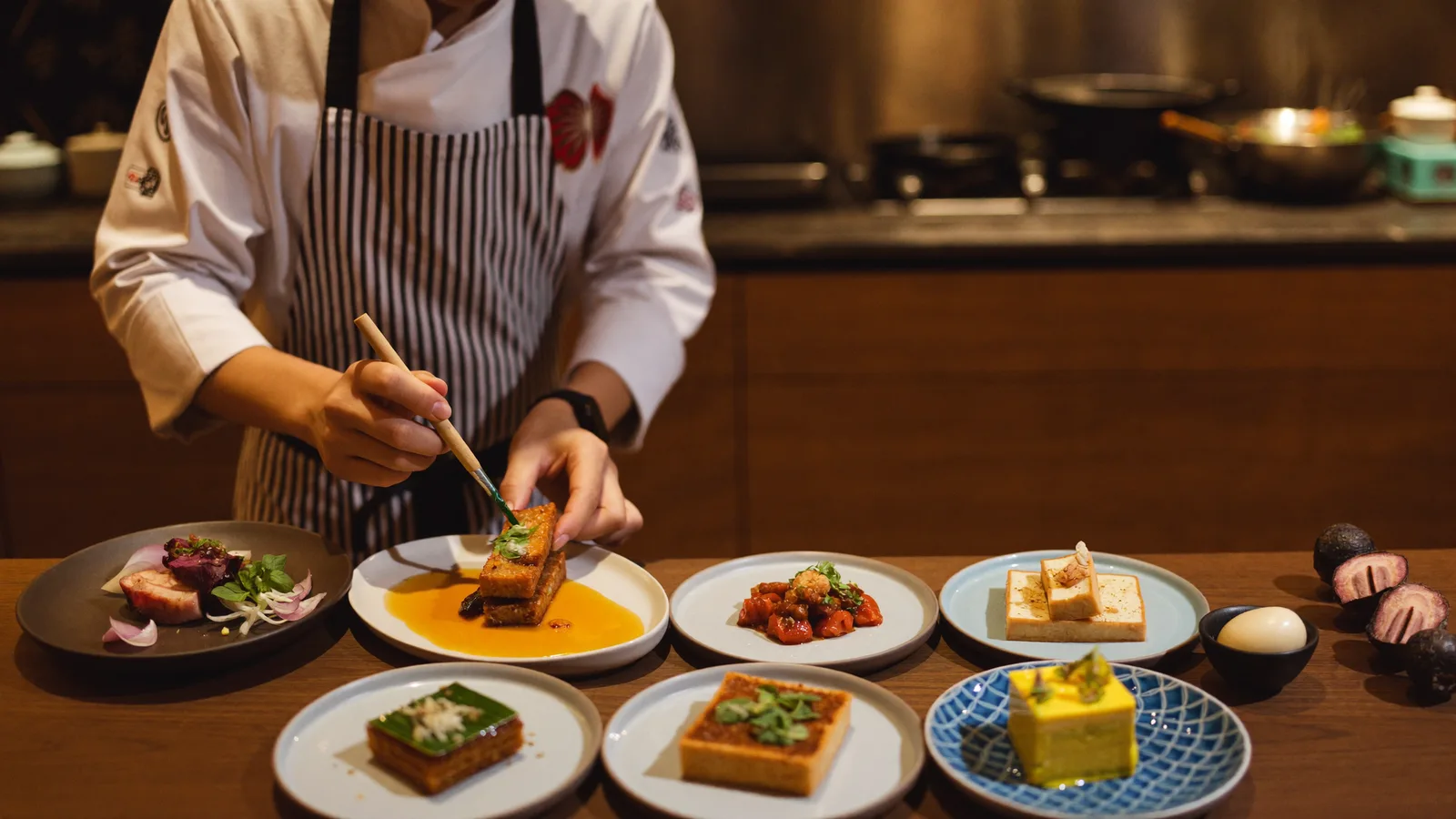 An elegantly plated modern tasting-menu course on handcrafted ceramic tableware, illustrating the TATE Sheung Wan reopening